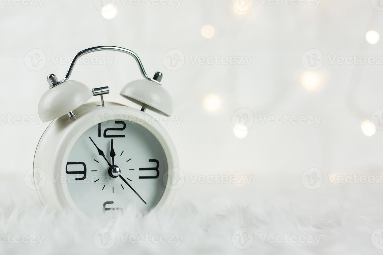 Christmas Retro alarm clock.decoratied with gift box and fir festive on blurred bokeh background.Celebration and Happy New Year Concept. photo