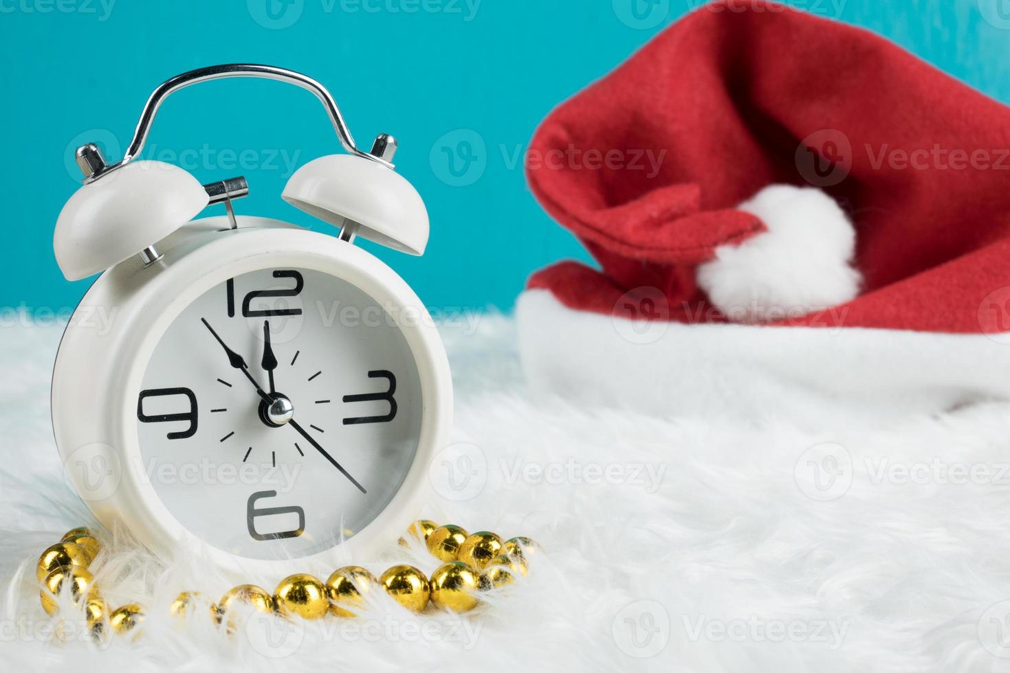 Christmas day theme decoration with hat santa and white retro clock.copy space for text.Celebration Christmas and x'mas concept.on green background photo