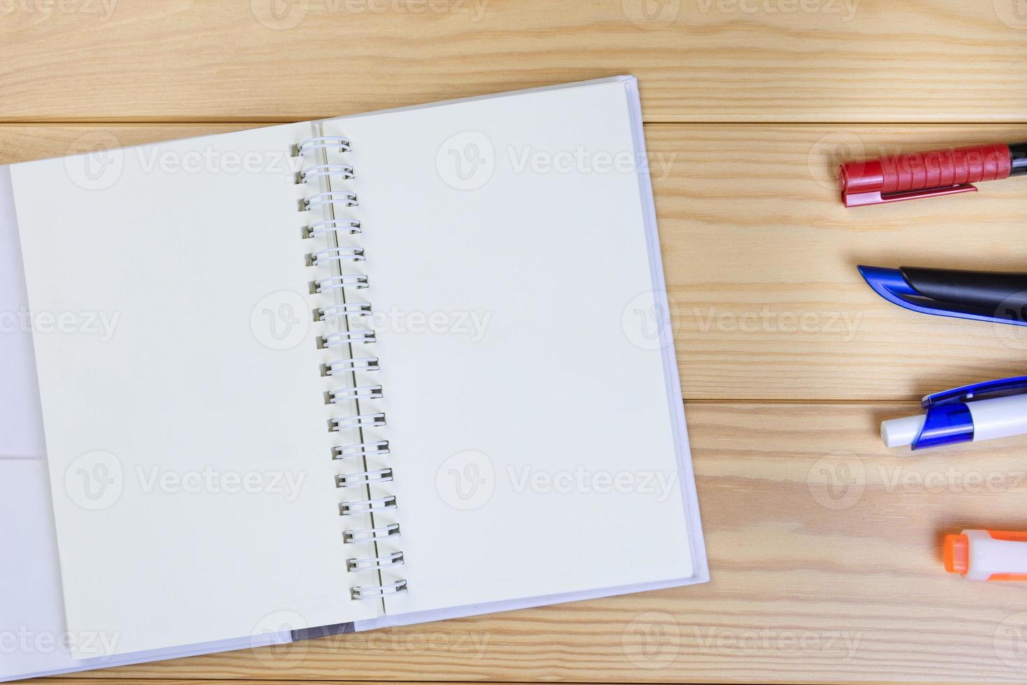 Note Book And Pen On Wooden Floor Background Space For Text. photo