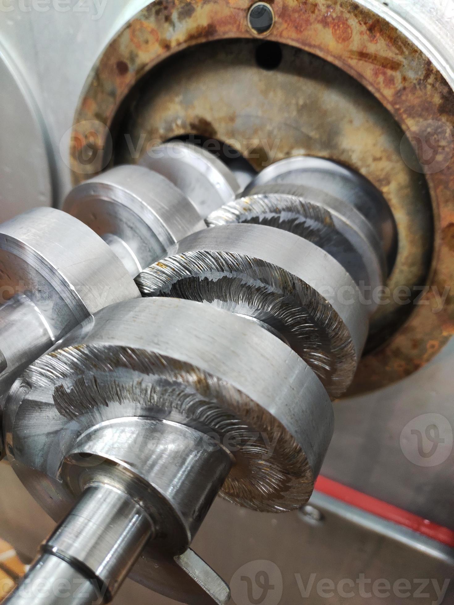 The feed screw for the meat grinder is sticking out of the machine