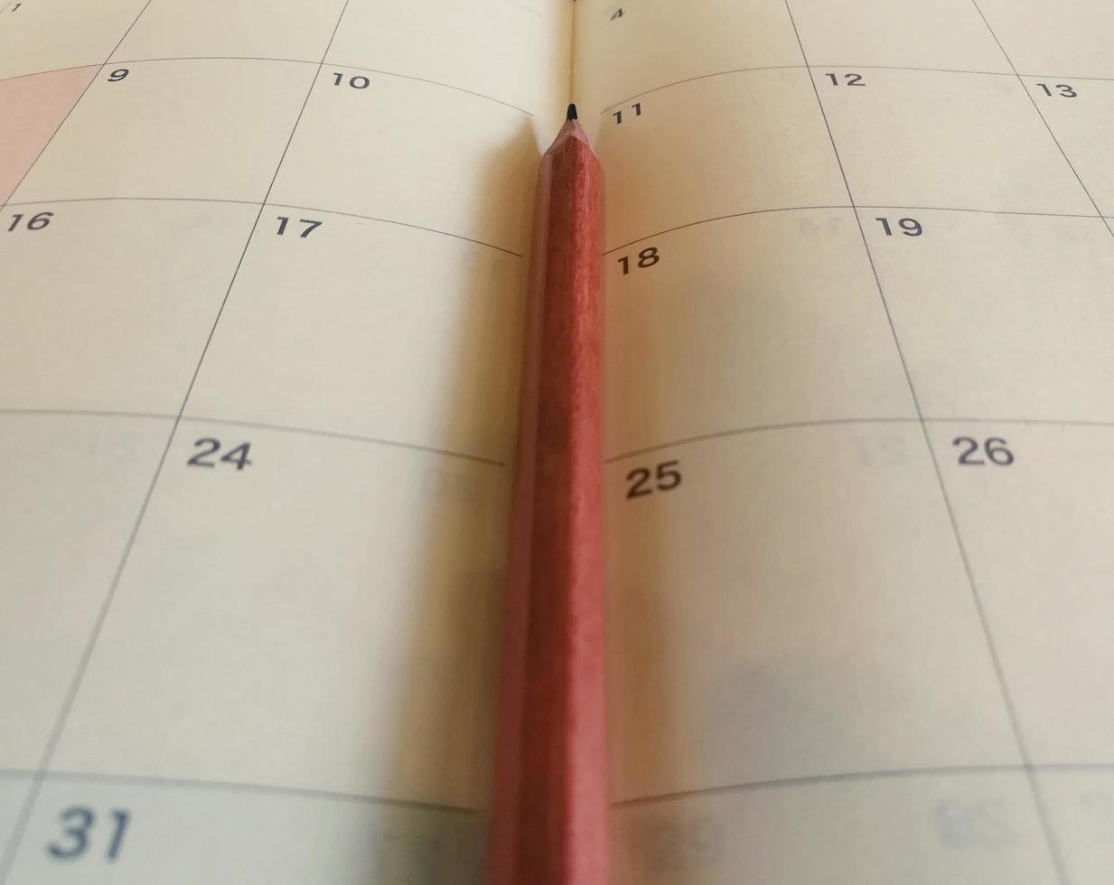 Pencil on the calendar planner. photo