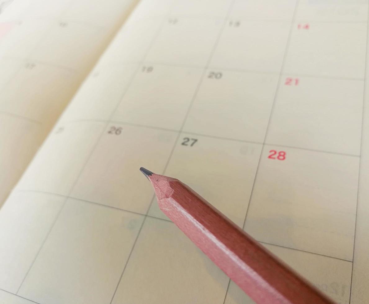 Pencil on the calendar planner. photo