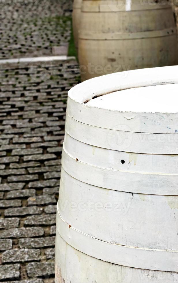 White wooden barrel on a cobblestone street.Vertical image. photo