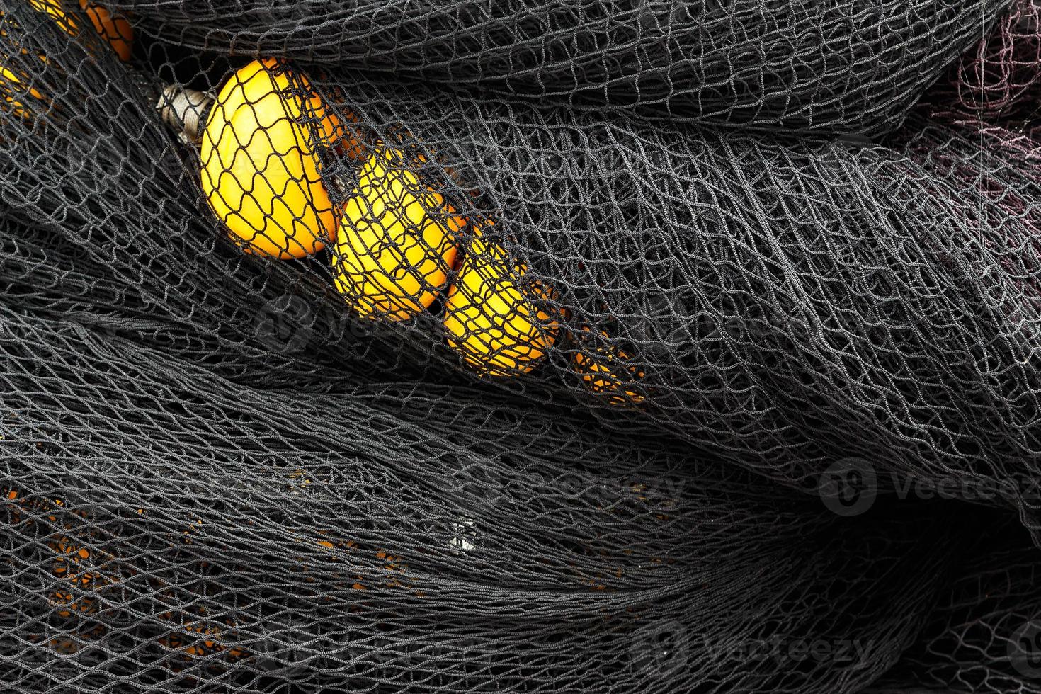 Black fishing net with yellow corks in Santona harbour, Cantabria, Spain. Horizontal image. photo