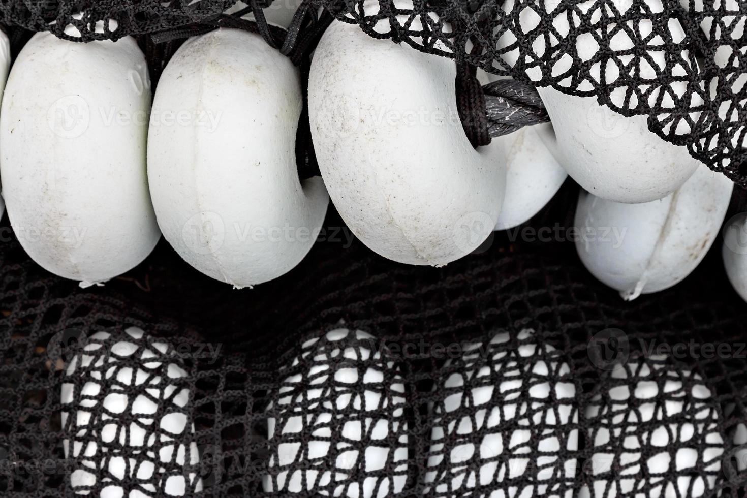 Black fishing net with white corks in Santona harbour, Cantabria, Spain. Horizontal image. photo