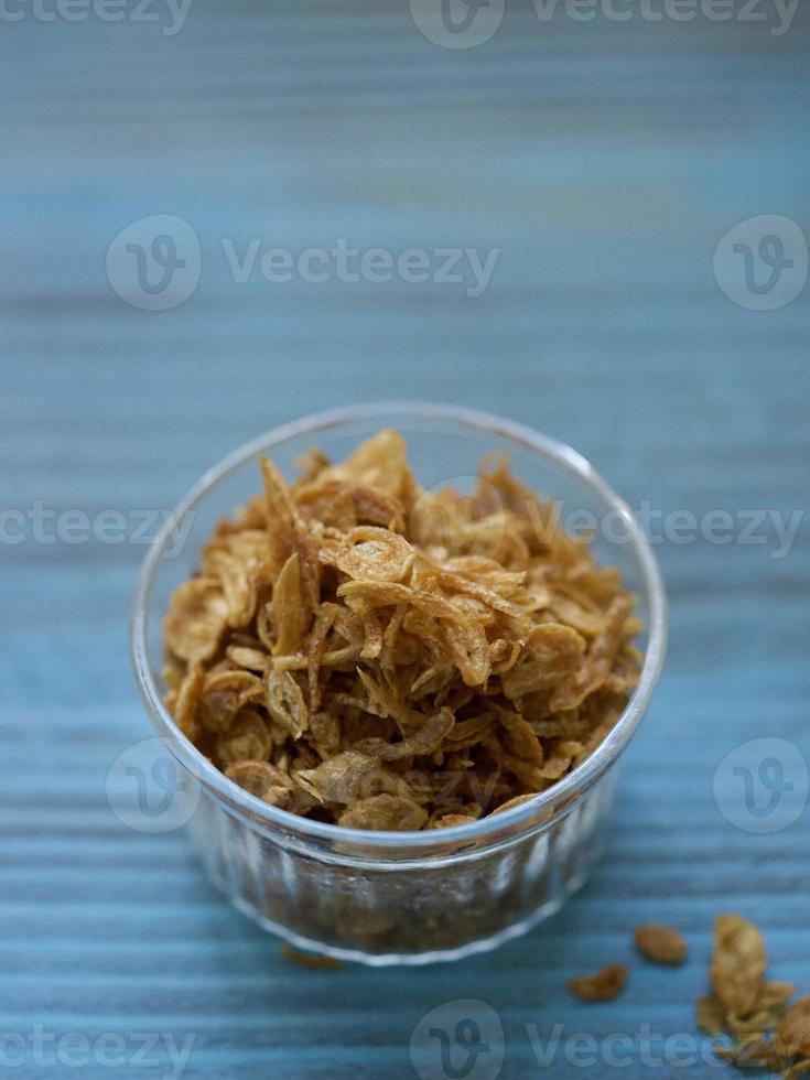 High angle view of deep fried shallots on the blue table photo