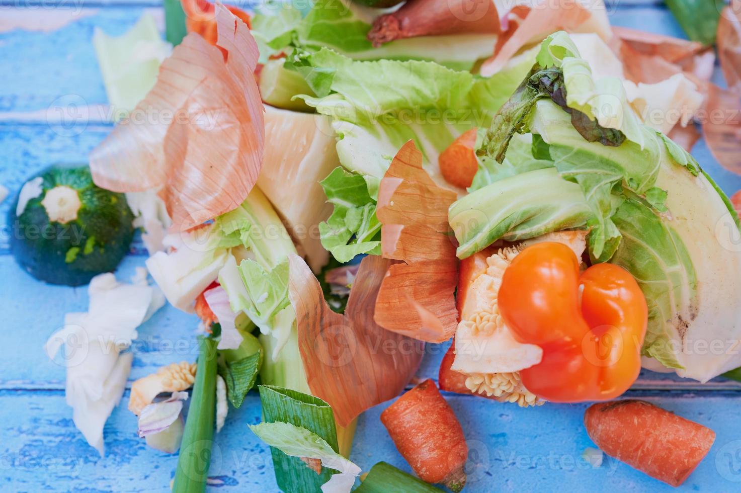 organic vegetables waste against blue wooden surface photo