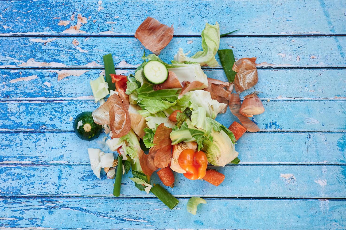 organic vegetables waste against blue wooden surface photo