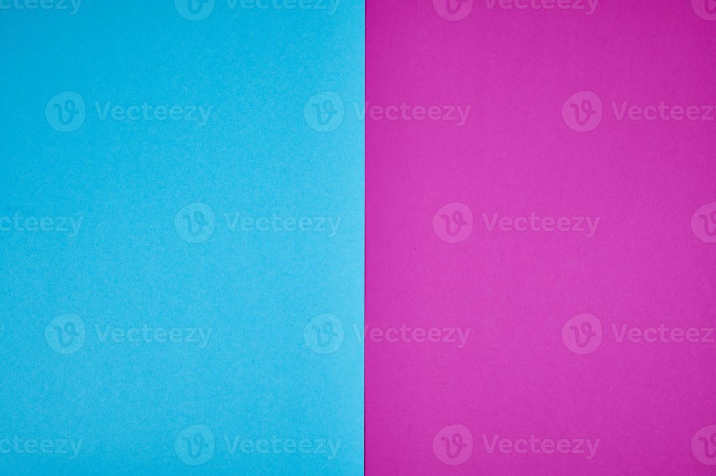 blue and magenta colored papers laid together as background photo with copy space