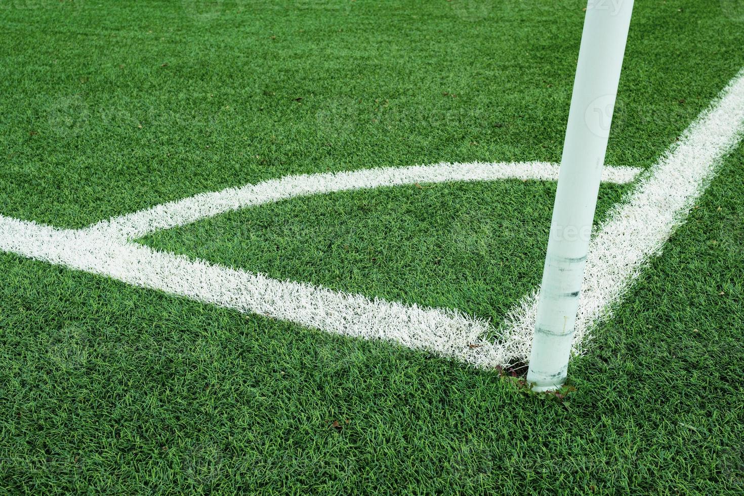 white lines which mark the corner on a soccer field photo