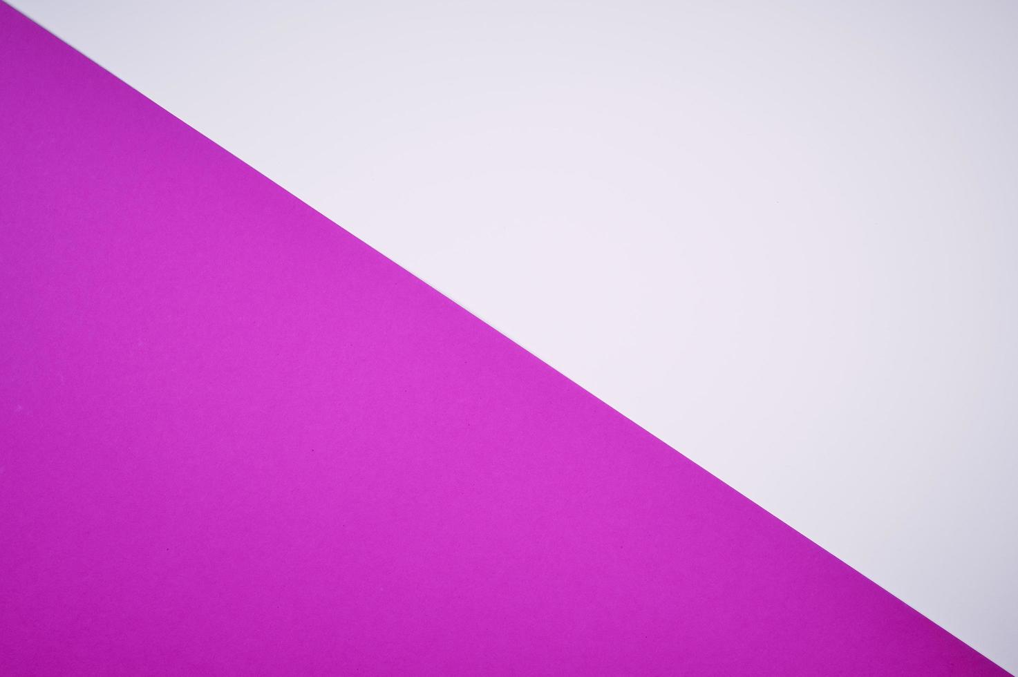 magenta and white colored paper laid diagonal together as background photo