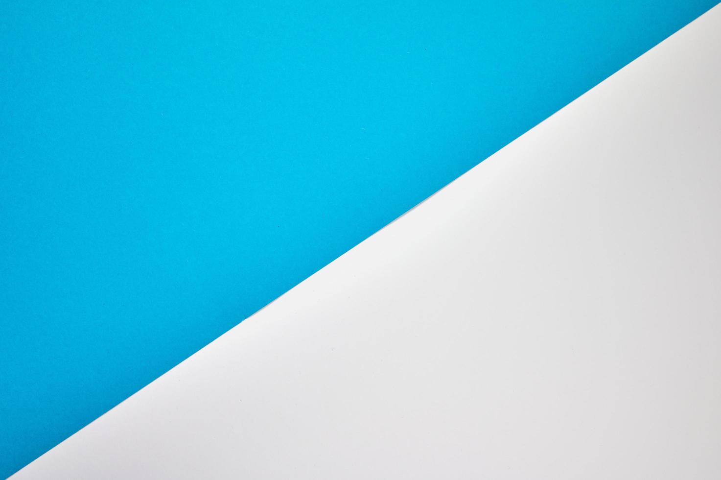 blue and white colored paper laid diagonal together as background photo