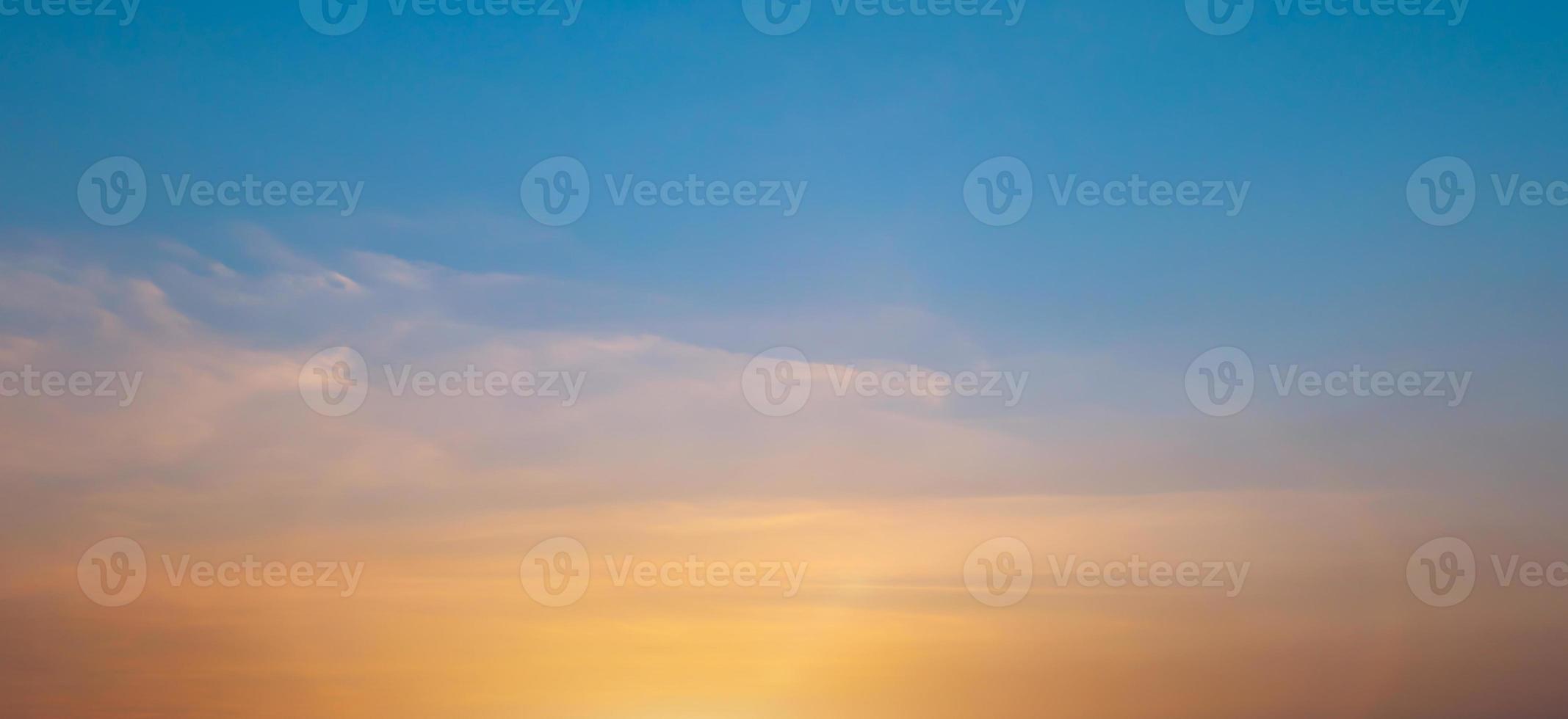 Bright orange sunset sky background with gentle colorful clouds, soft focus photo