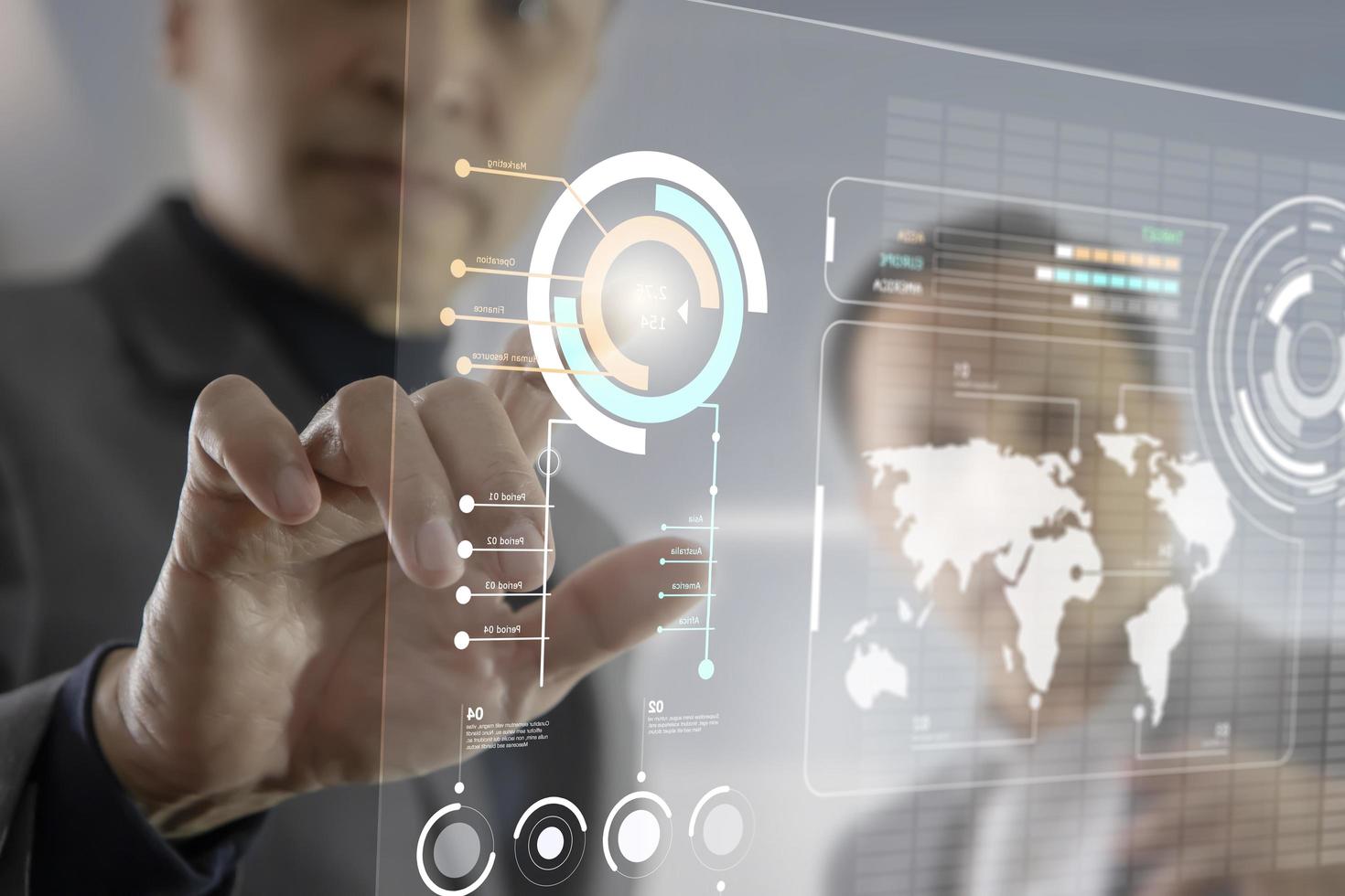 Two Asian businessmen interacting with futuristic virtual touchscreen while analysing business information data photo
