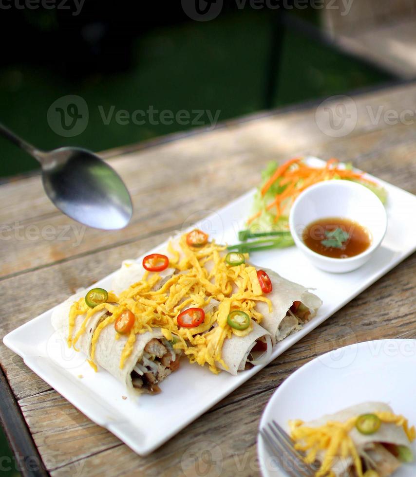 spring roll on wooden table photo