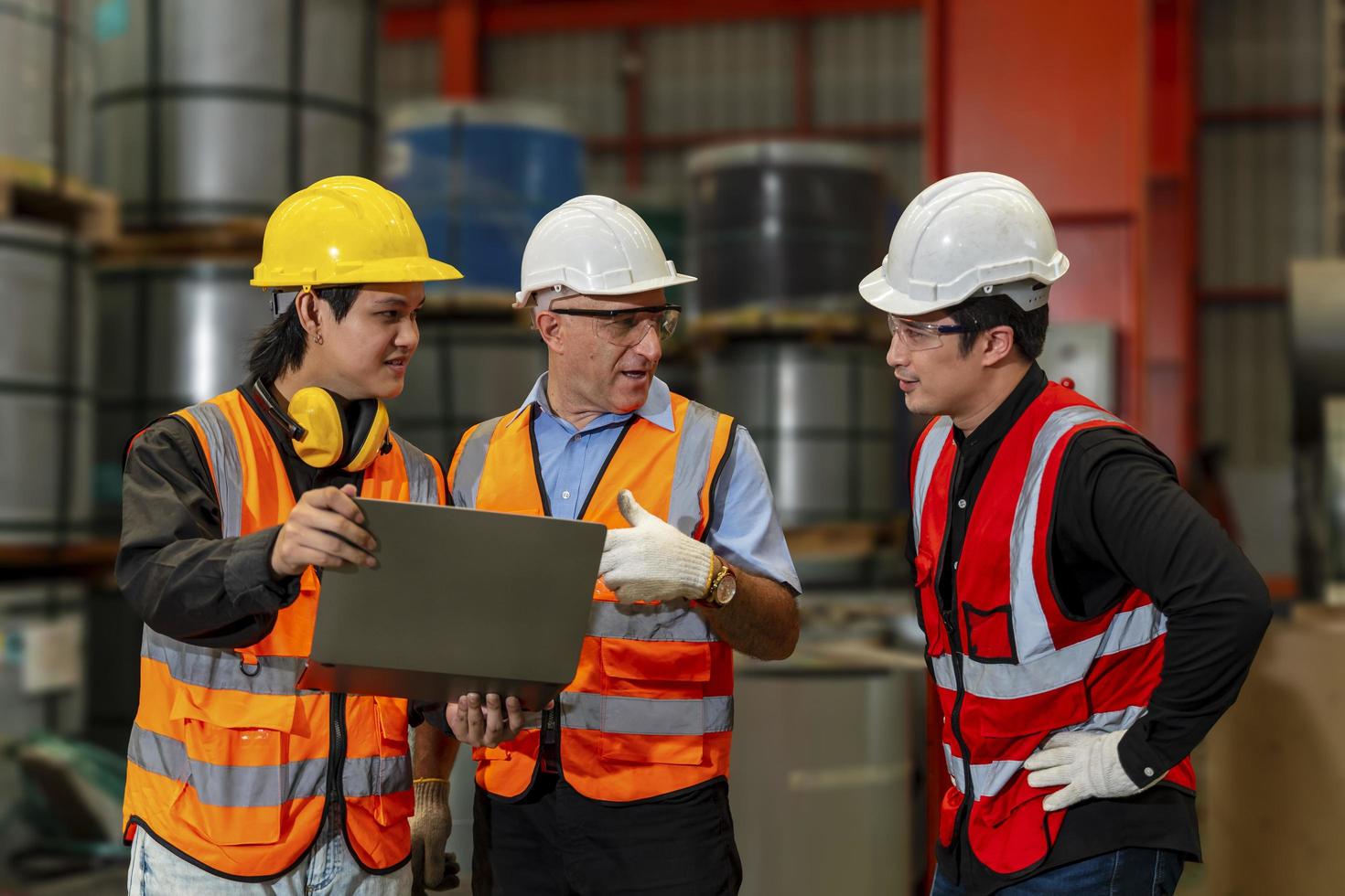 Team of diversity worker inspecting inside the steel manufacturing factory while listening to senior manager advice on improvement of capacity and productivity concept photo