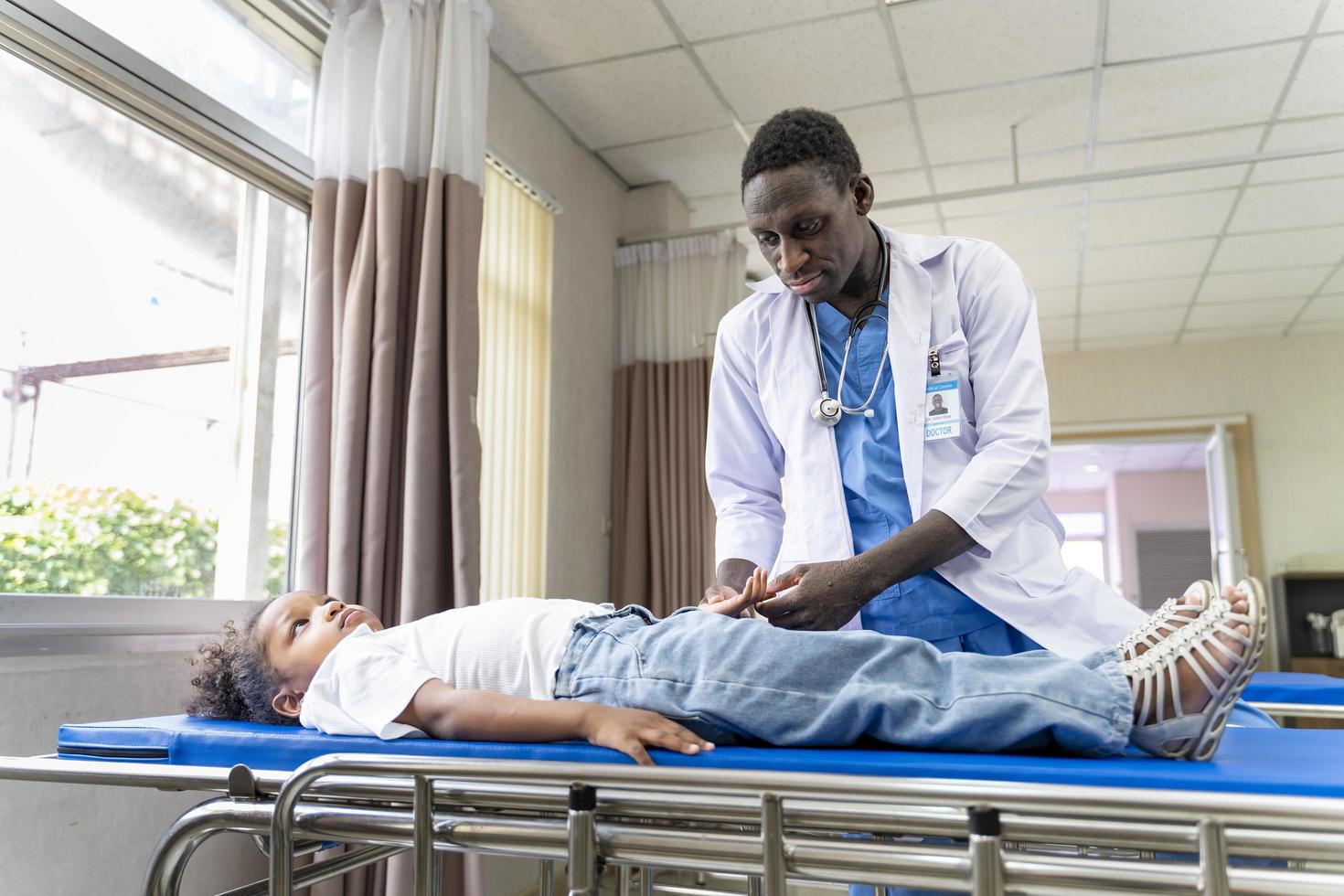 African american doctor and kid patient portrait on the hospital clinic appointment for diagnosis and medical checkup on nervous system and finger numbness concept photo