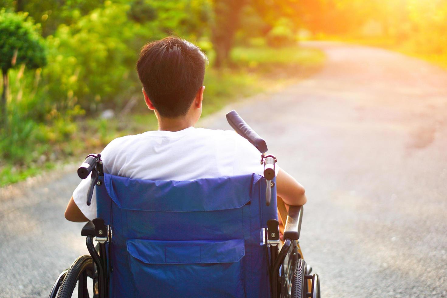 Patients or disabled sitting on a wheelchair looking forward with hope. Healthcare and medical concept. photo