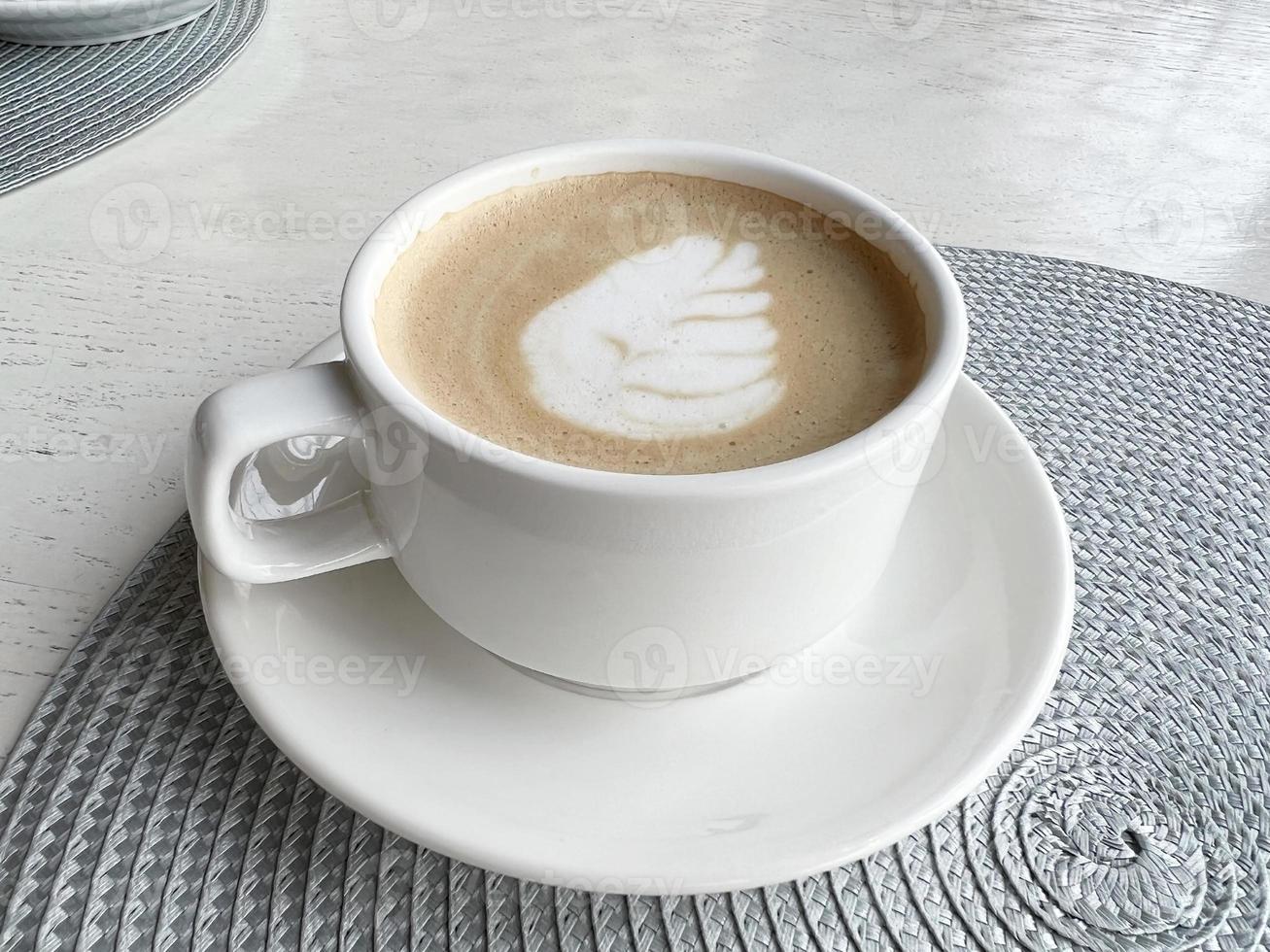 cappuccino. coffee cup saucer. patterned coffee foam photo