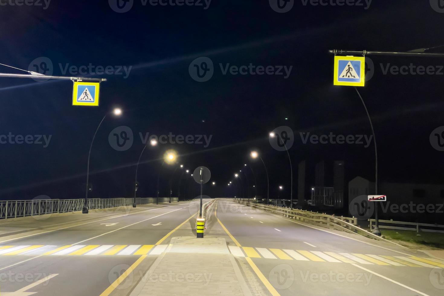 Pedestrian zone on the highway illuminated , at night photo