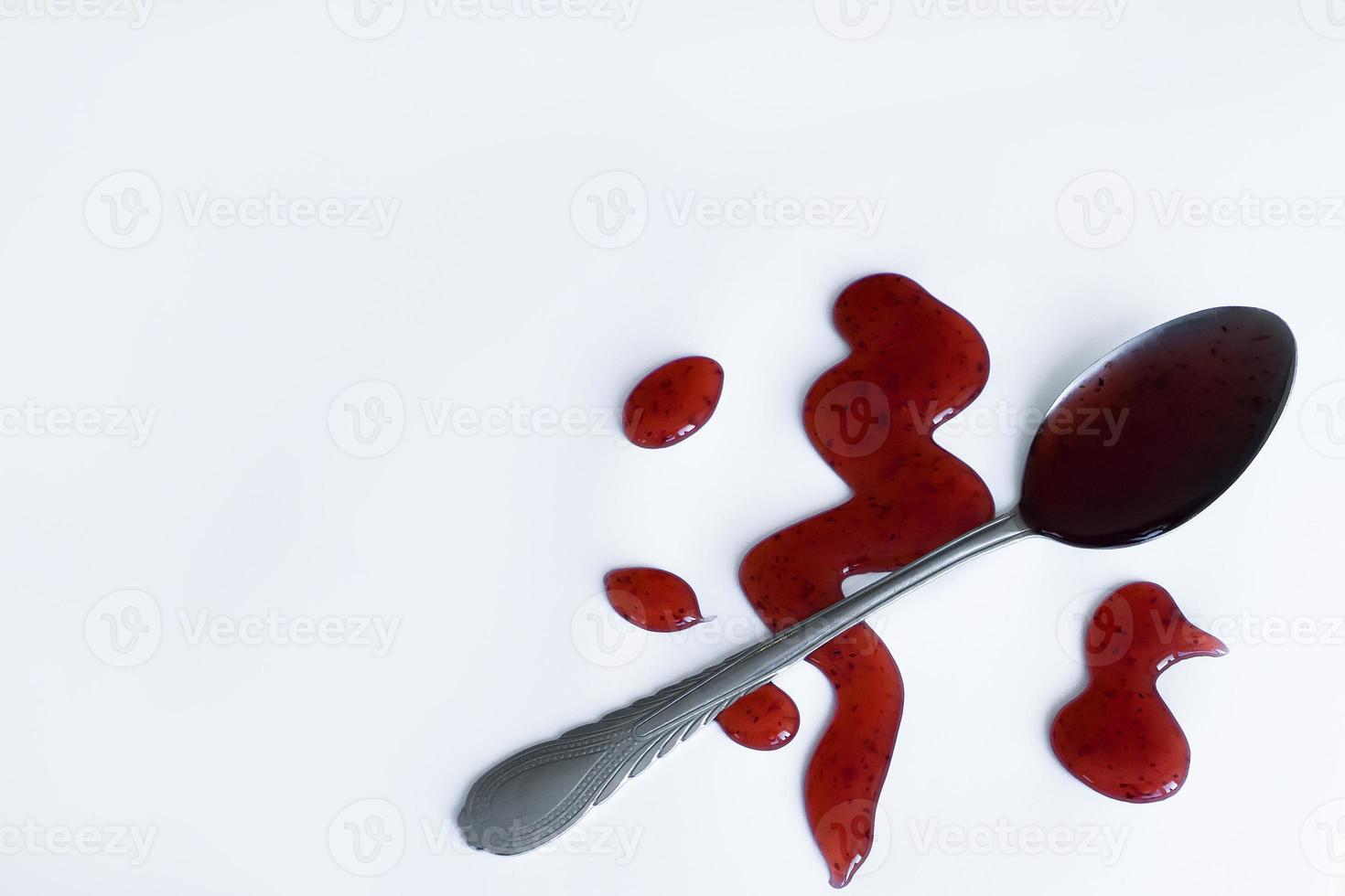 the drops of homemade sauce and a spoon on a white background photo