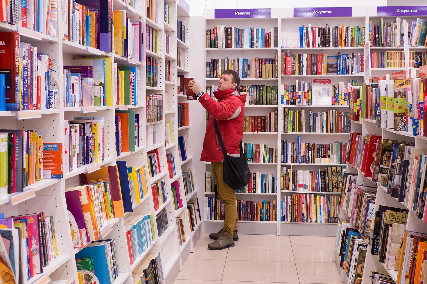 Ivanovo, Russia, February 21, 2021, a man chooses a book in a bookstore, editorial photo