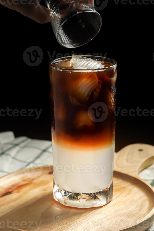 Fresh blending coffee Arabica with sweet coconut juice for health care drinking in home. drinks in summer on dark background copy space. photo