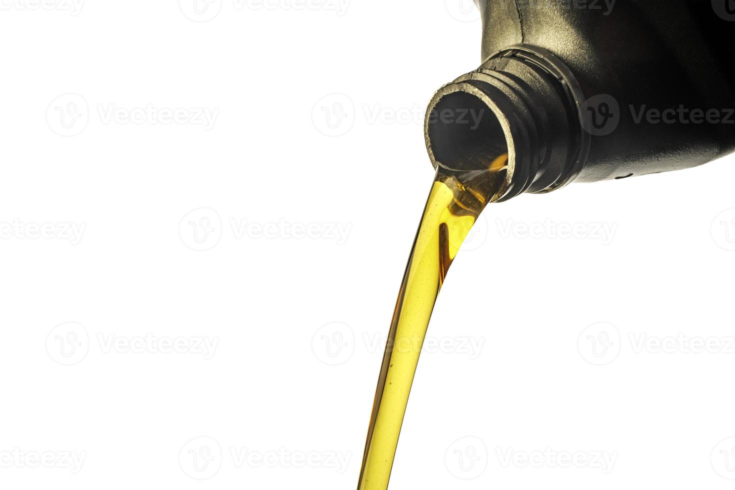 Car lubricant flows from gray bottle on isolated white background. photo