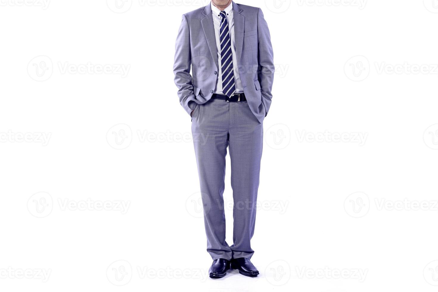 Businessman wearing an elegant suit over white background. Well-dressed senior man in the studio That emphasizes thoughtful thinking, thinking carefully. photo