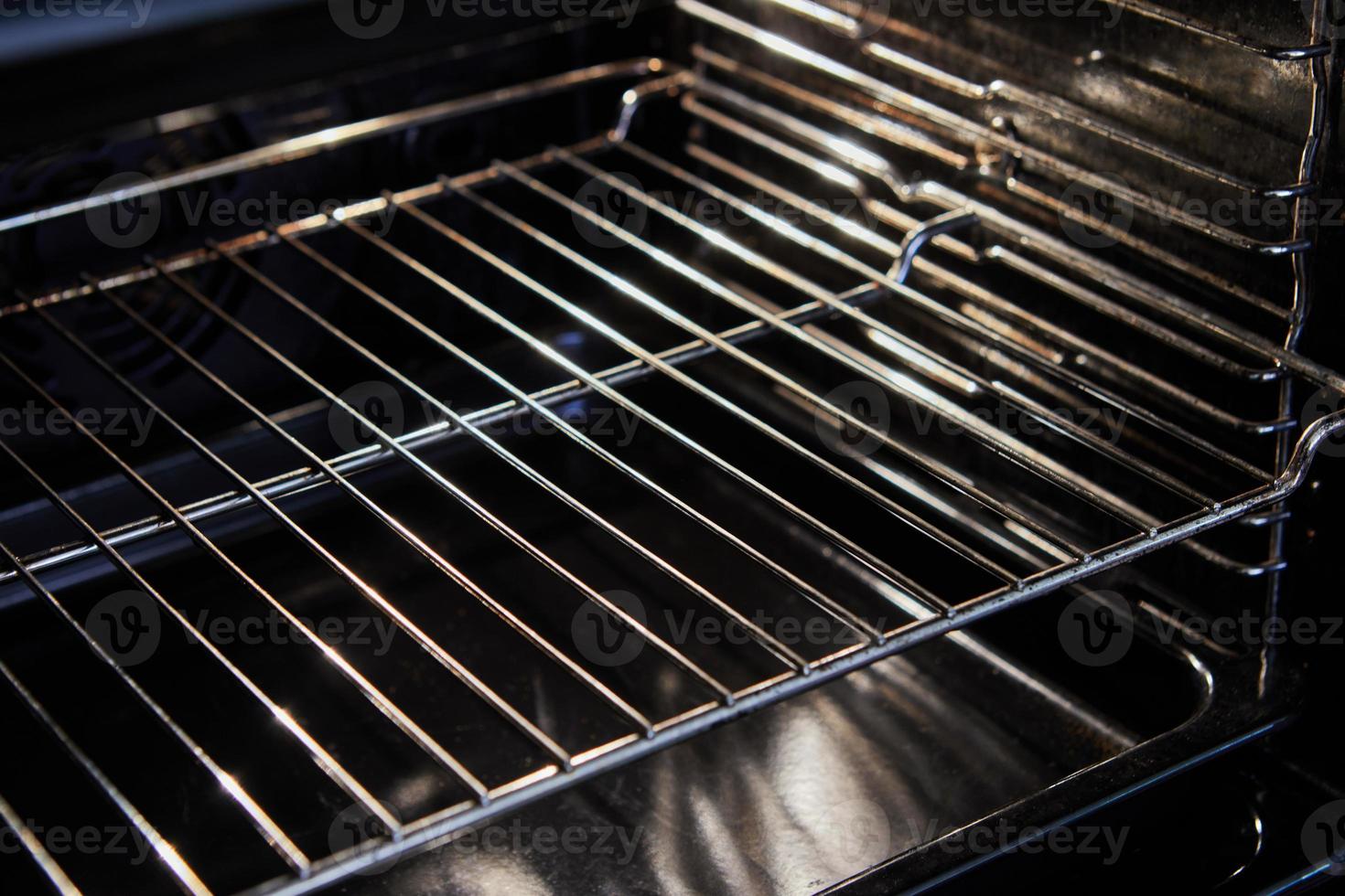 Electric oven hob inside with grate for dishes photo
