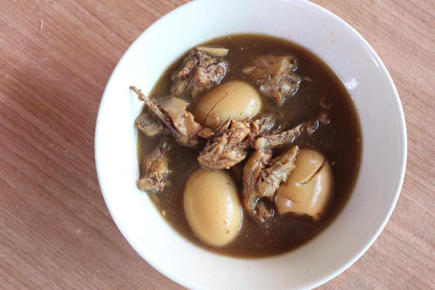 Stewed Eggs and pork on the brown table. photo