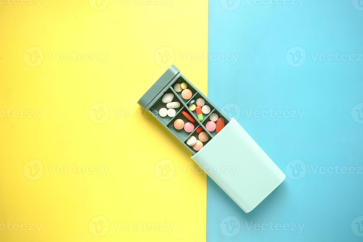 close up of medical pills in a pill box on table photo