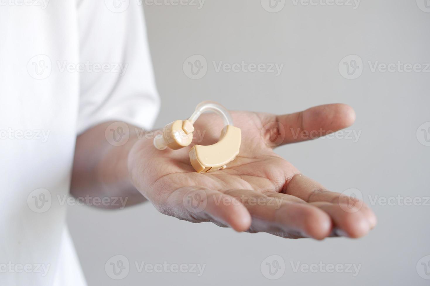Hearing aid concept, a young man with hearing problems. photo