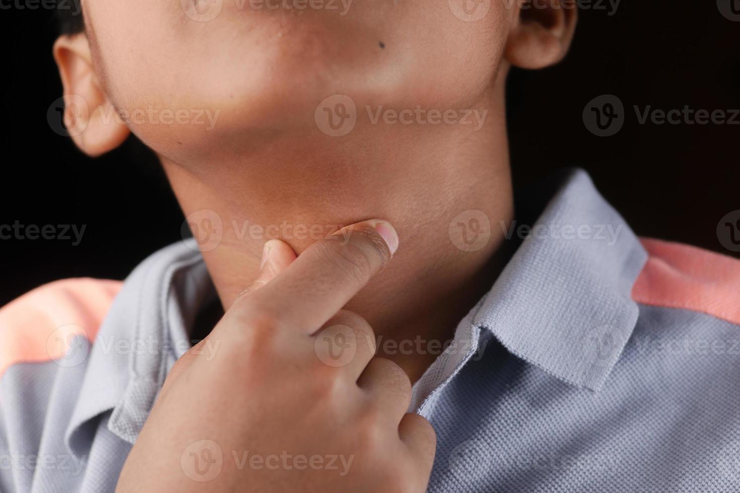 teenage boy suffering throat pain close up photo