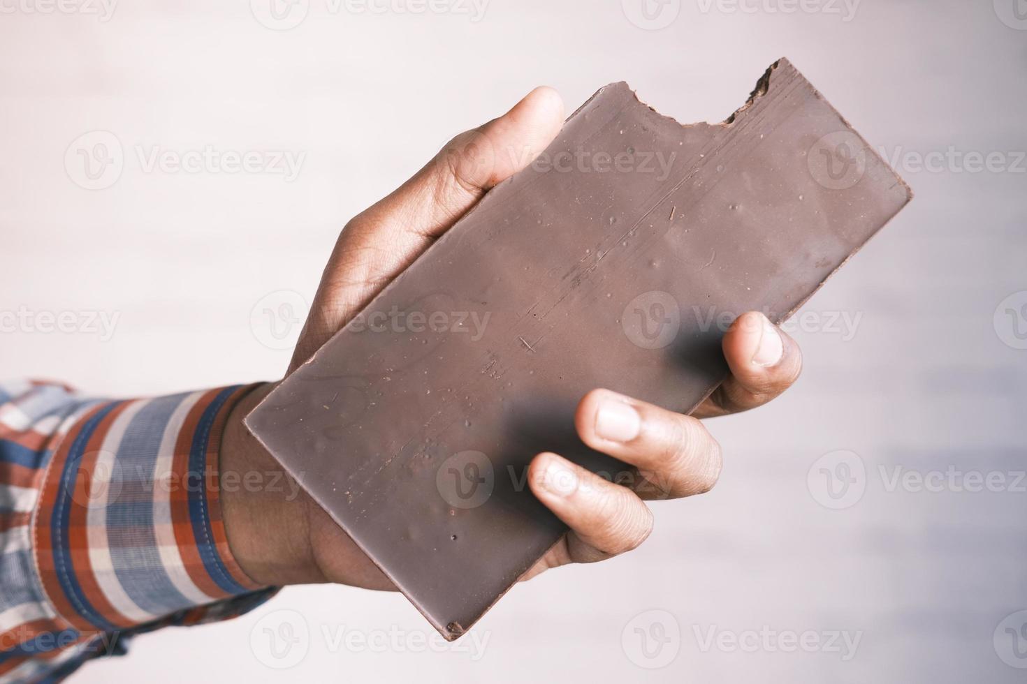 holding a dark chocolate close up photo