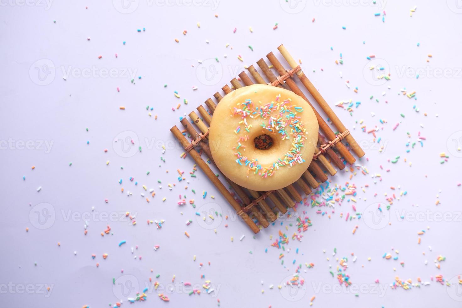 slow motion of dropping sprinkles on chocolate donuts photo