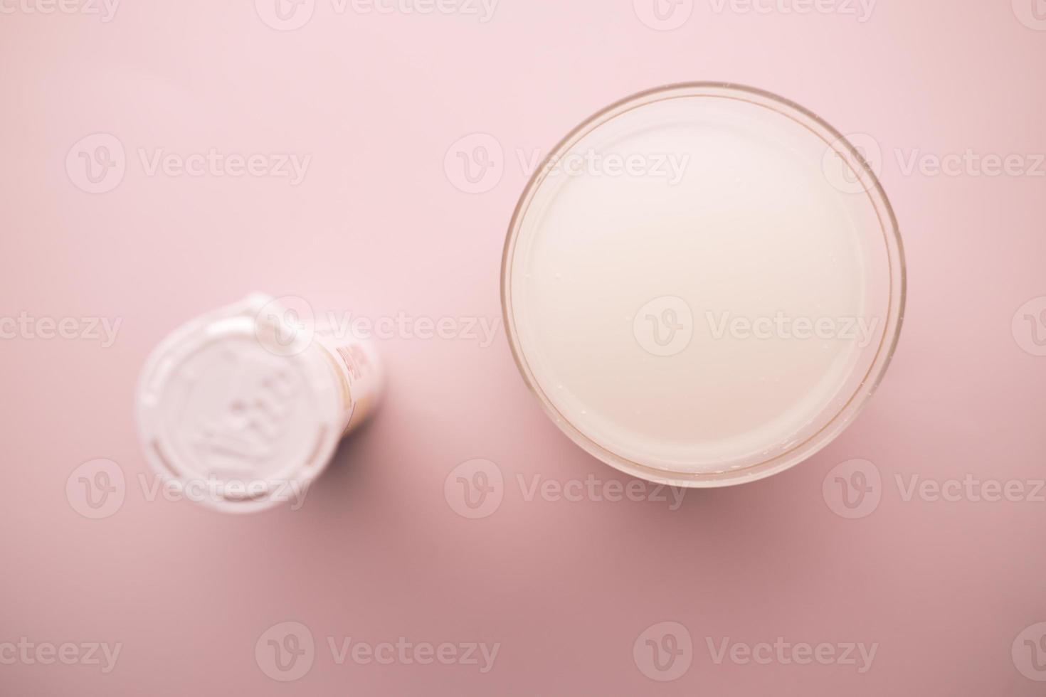 Effervescent soluble tablet pills and glass of water on table photo