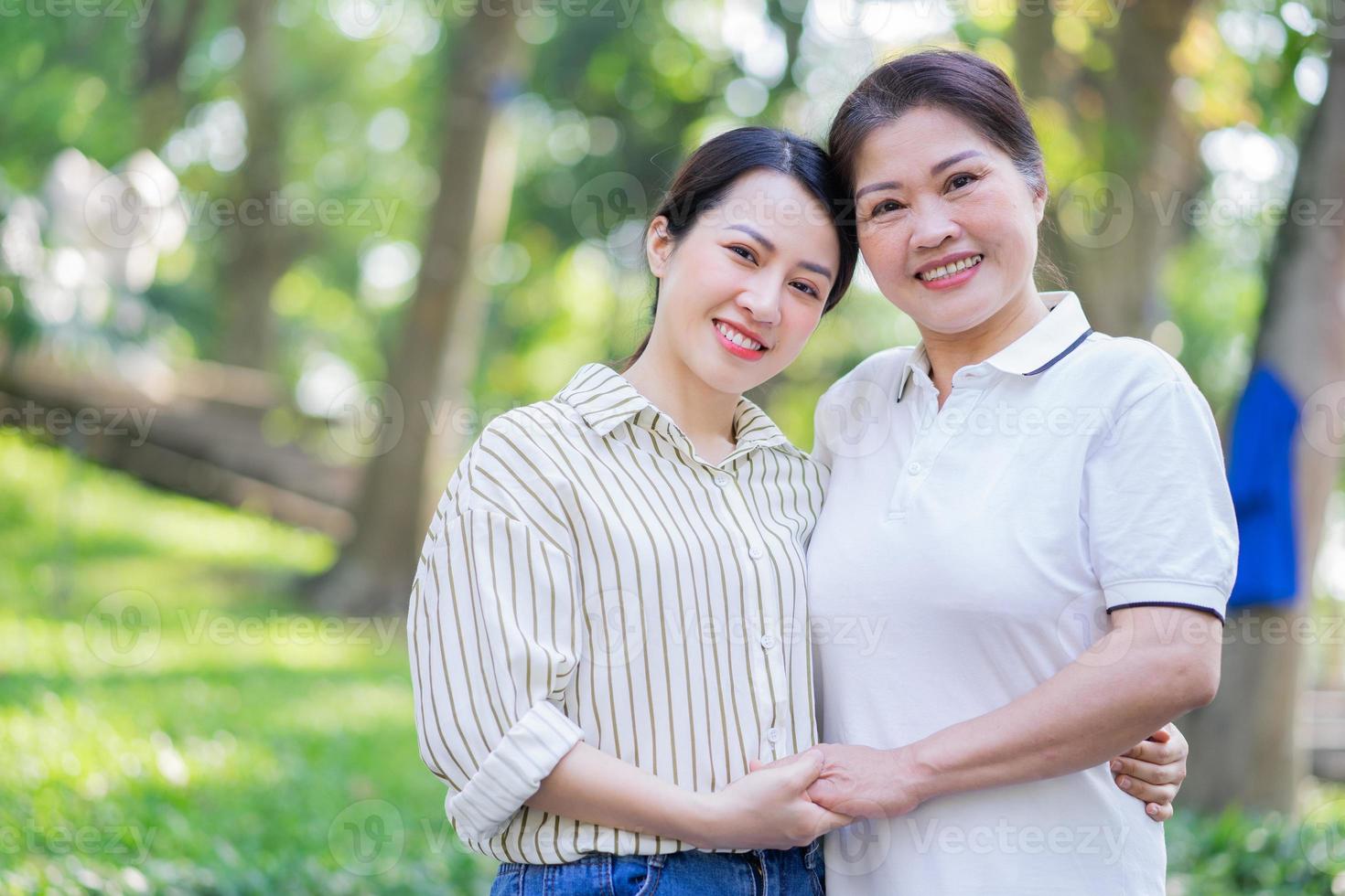 Portrait of Asian mother and daughter at park photo