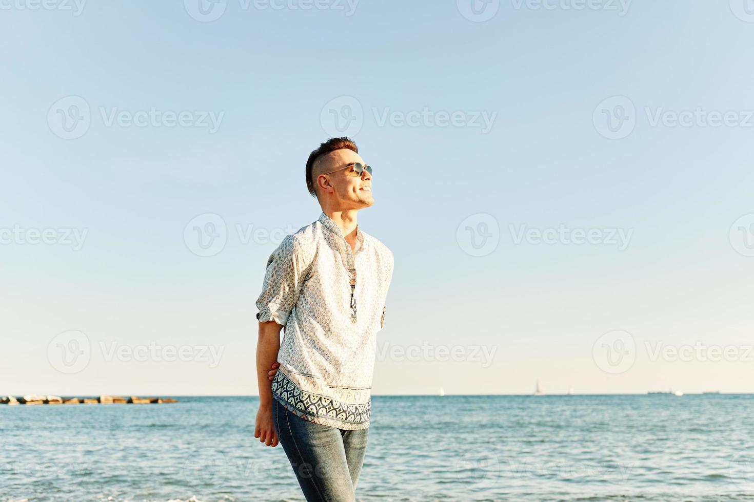 Portrait of an attractive man on the beach photo