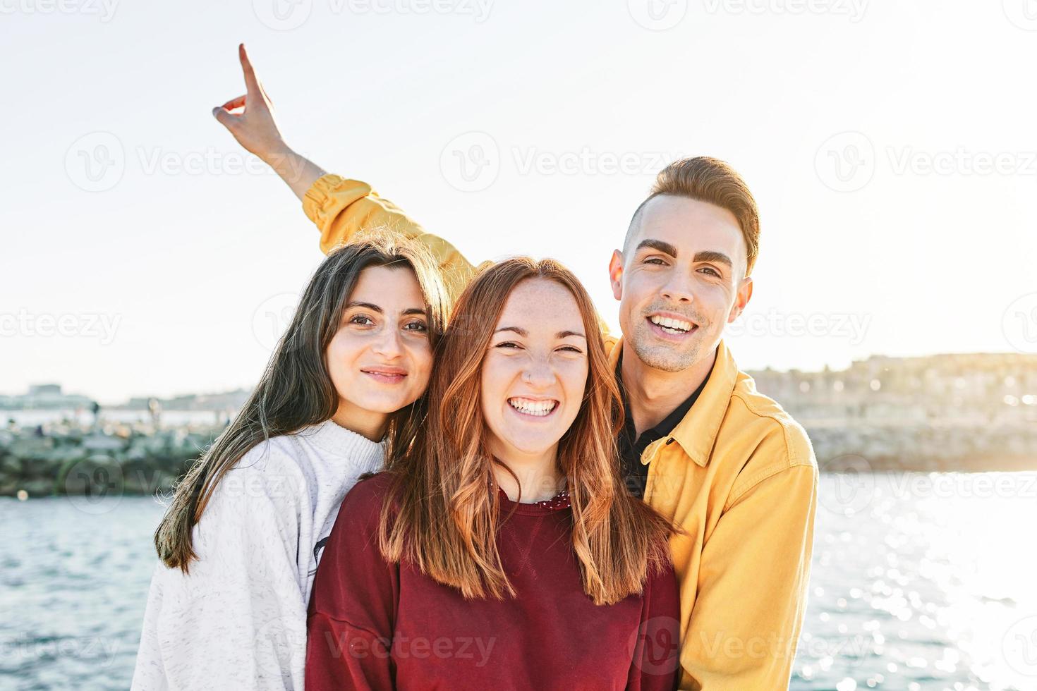 Young friends having fun at the beach photo