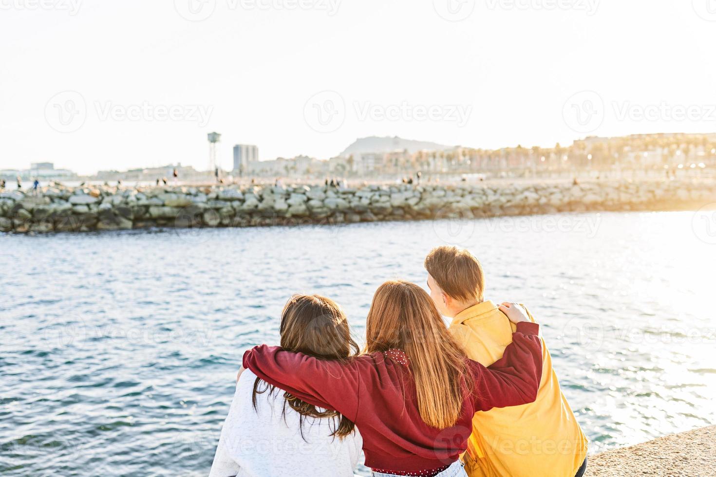 Friends with their backs to each other and hugging photo