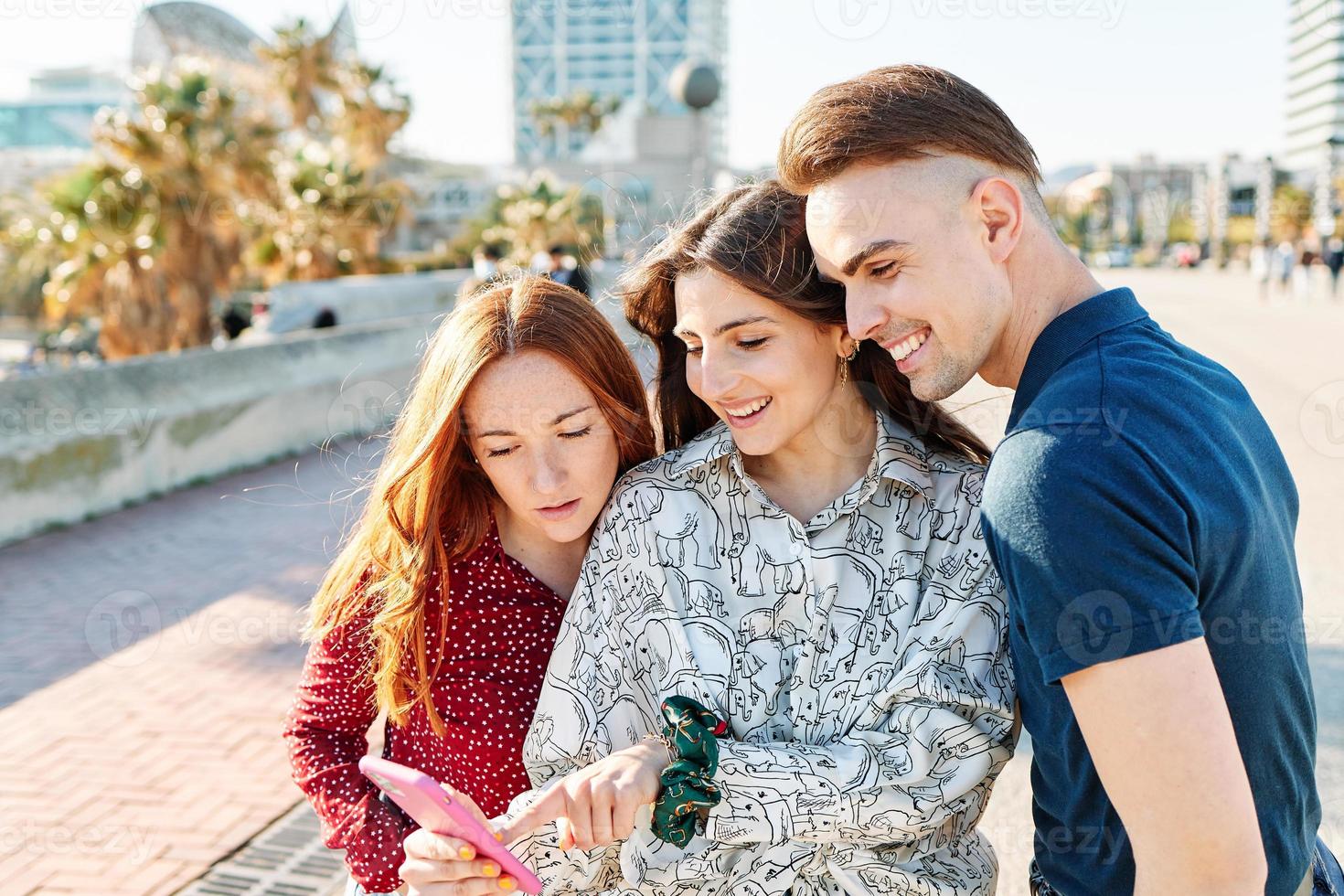 Friends laughing with mobile phones photo