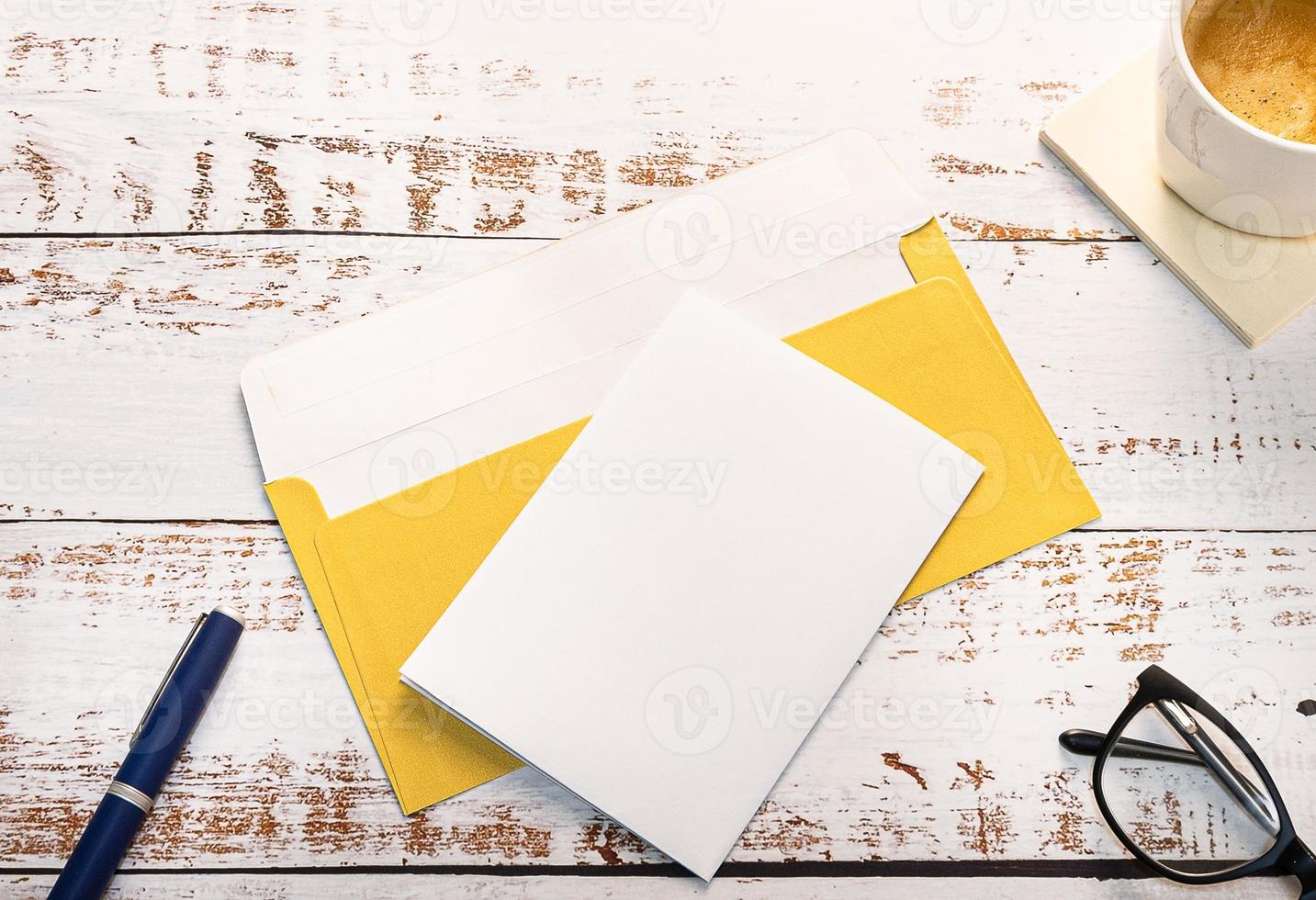 A Craft envelope, white paper, pencil, coffee and glasses photo