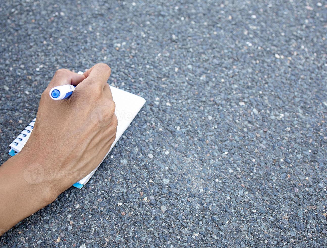 Person writing down her new ideas in a notebook photo