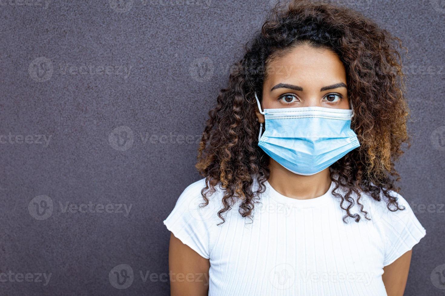 A beautiful African American woman wearing a face mask. photo