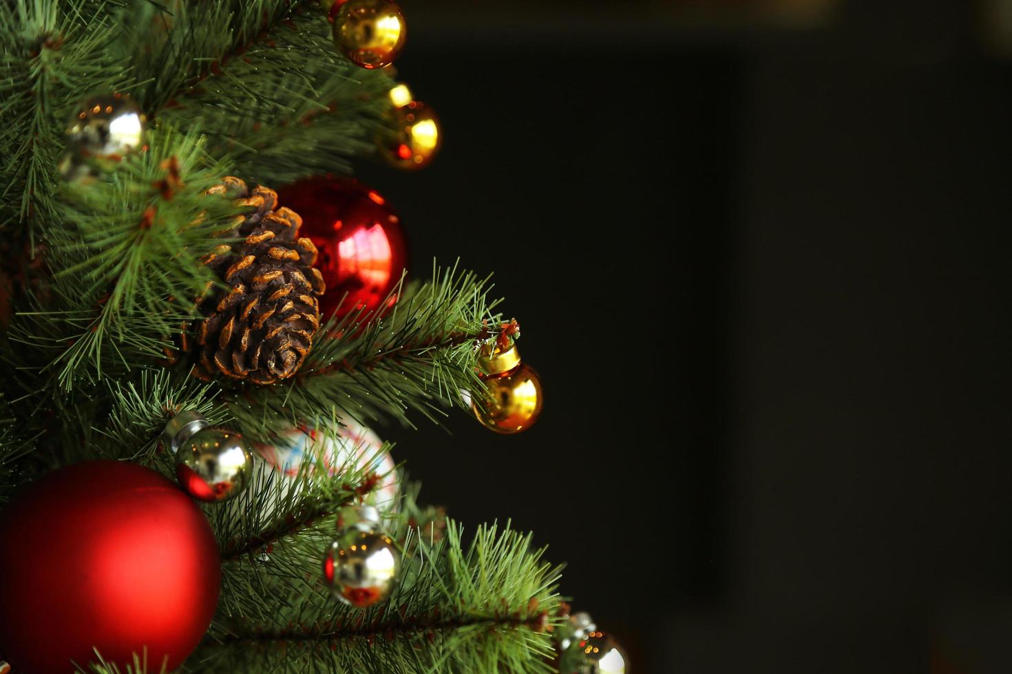 Decorated Christmas tree on dark background. photo