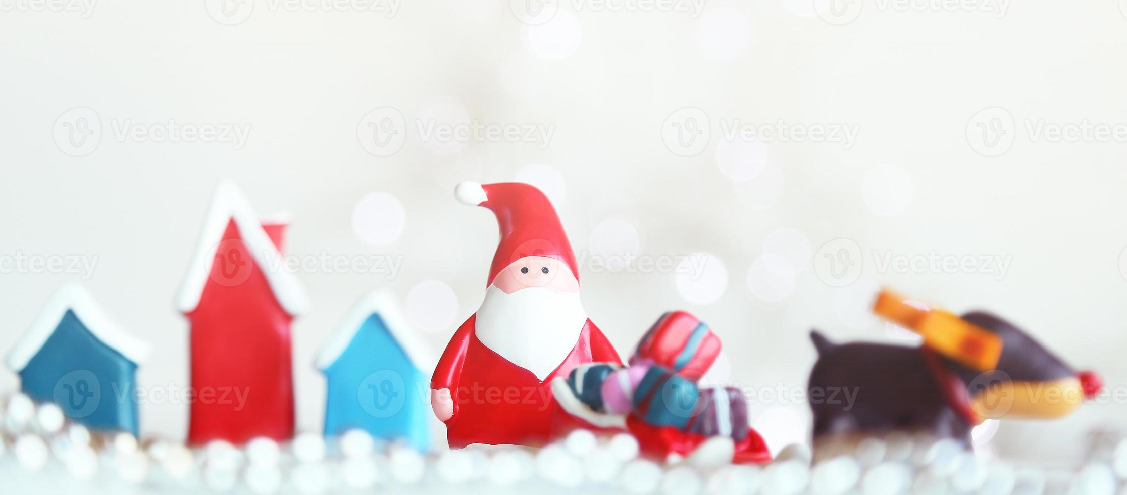 Santa Claus dolls and Christmas decorations box on abstract light background photo