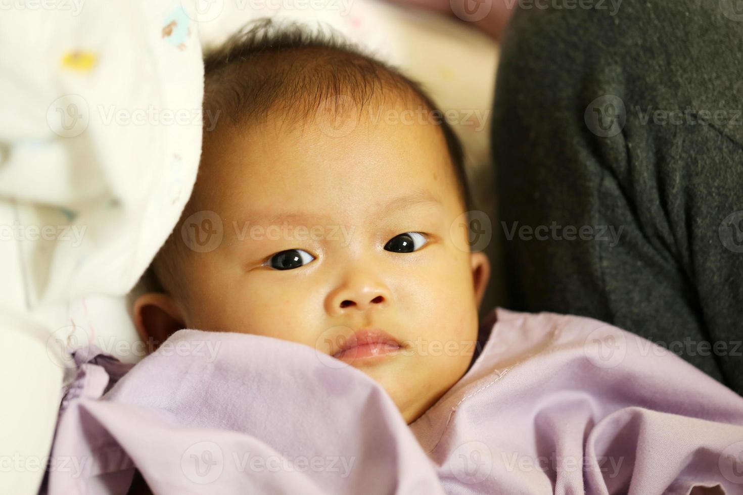 Sick asian baby in a hospital. Child got fever and admit in hospital. photo