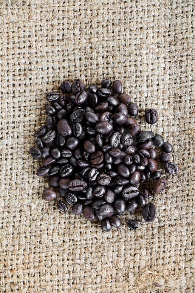 Coffee beans on burlap sack photo