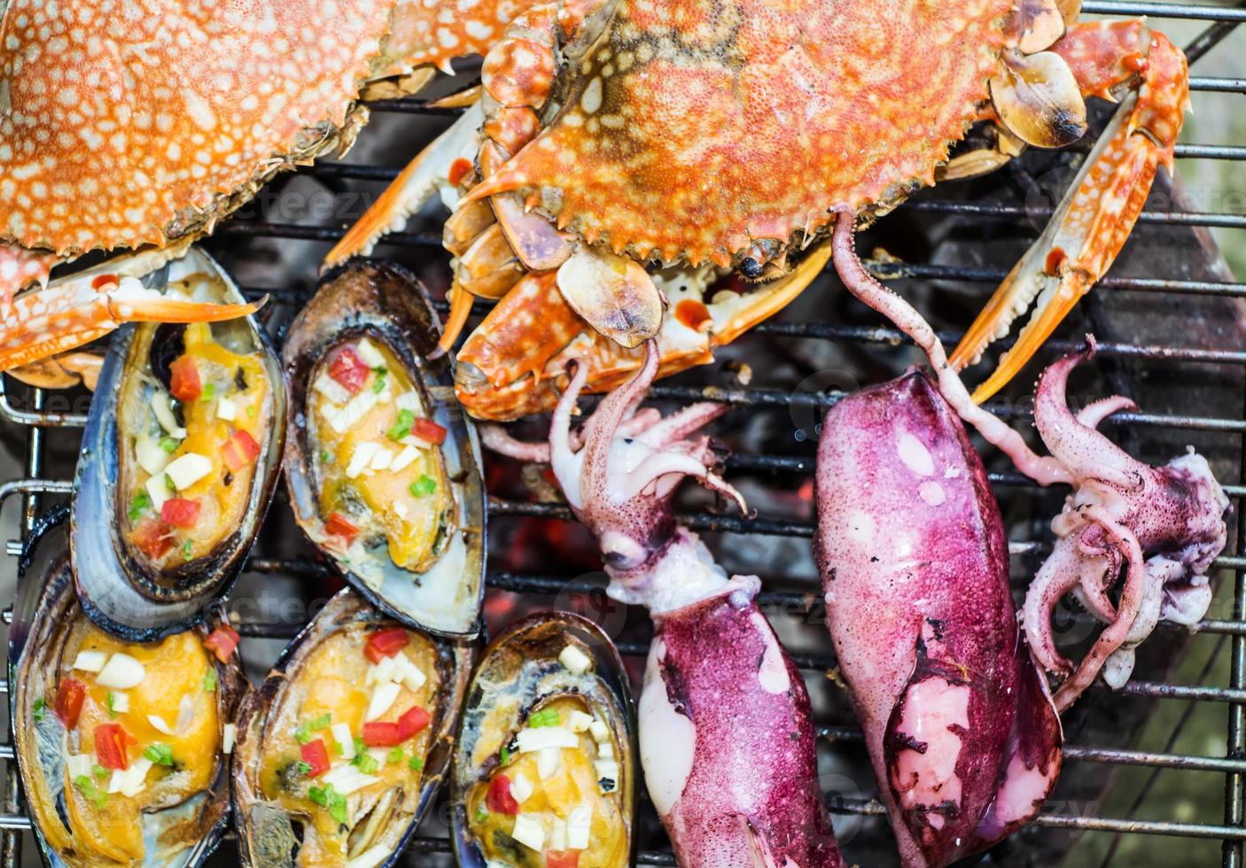 crabs shrimps on charcoal grill photo